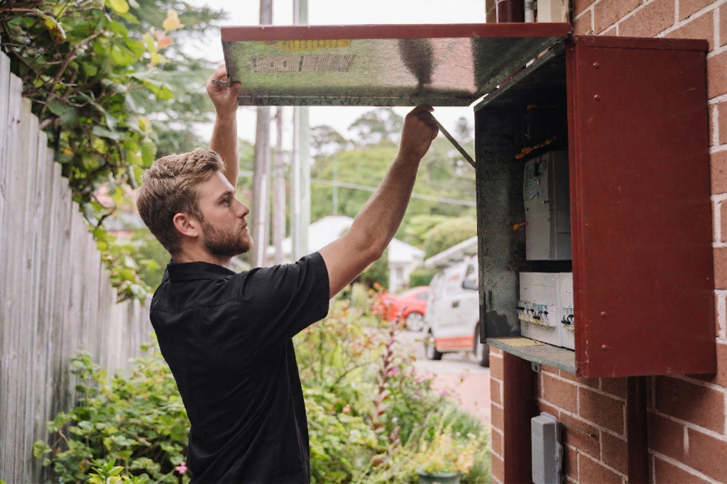 Electrician installing downlights in a Glebe home